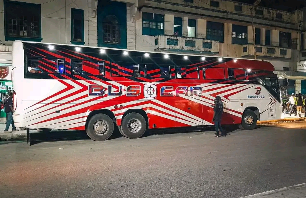 Buscar coach on a city street at night
